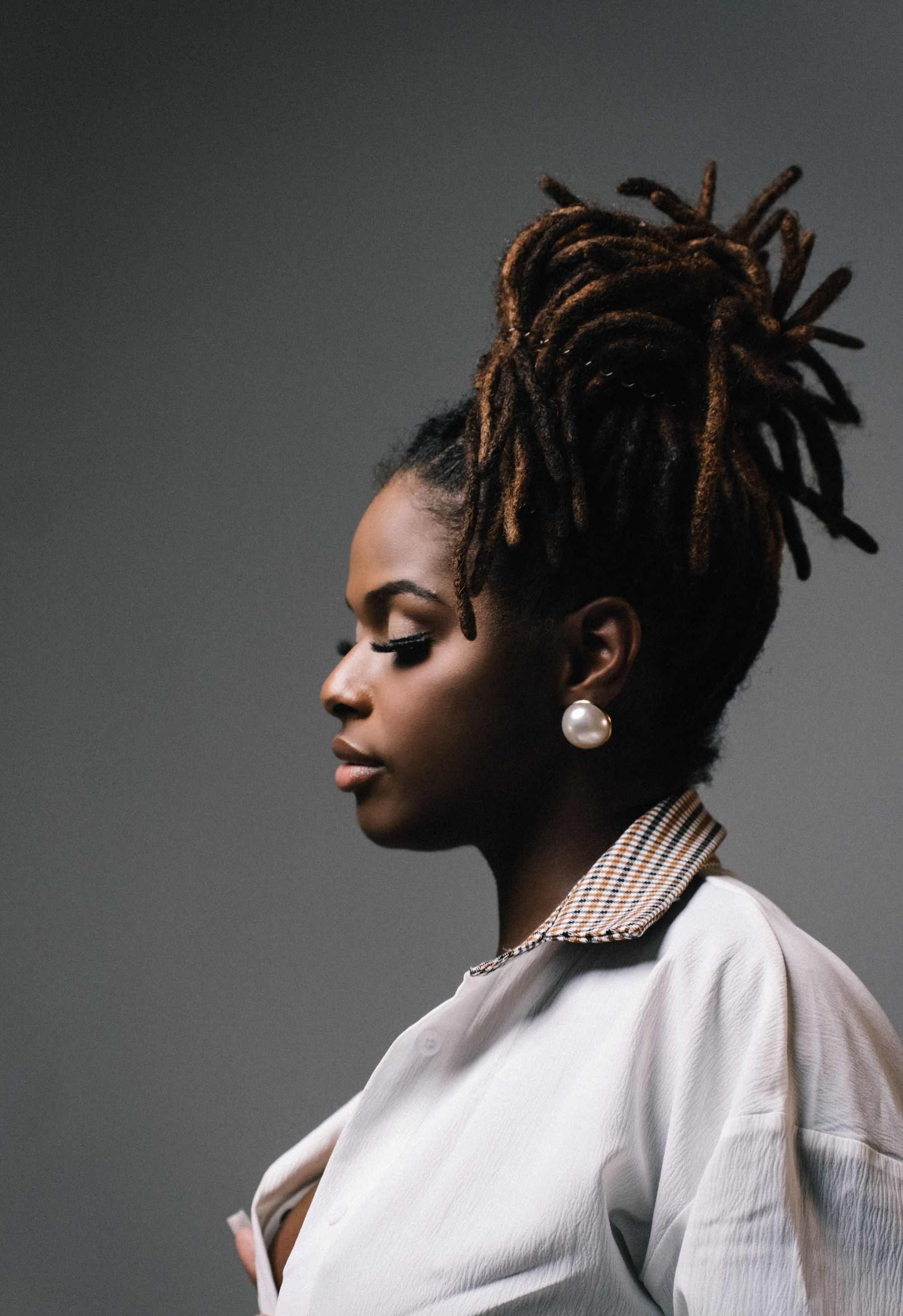Profile of a woman with styled locs